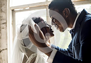 Newlywed African Descent Groom Open Bride Veil Wedding Celebration photo