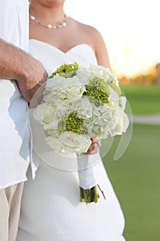 Newlywed couple with bouquet