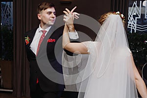 Newlywed couple first dance at ballroom, bride and groom dancing