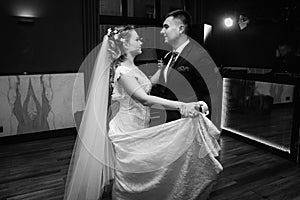 Newlywed couple first dance at ballroom, bride and groom dancing