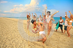 Newlywed couple have fun doing the limbo photo