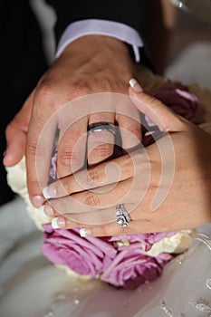 Newlywed couple holding hands