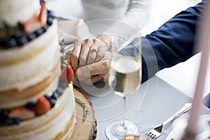 Newlywed Couple Holding Hands Together