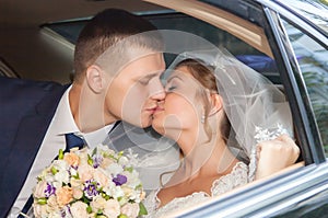 Newlywed Couple Kissing Each Other In car