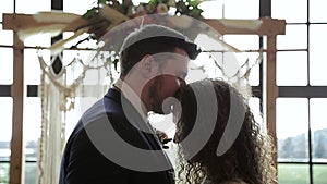 Newlywed couple kissing forehead at wedding alter, quiet moment, marriage. HD 24FPS.