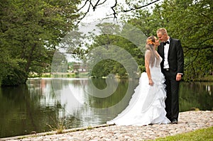 Newlywed couple by lake