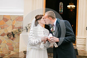 Newlywed couple releasing doves when leaving church after wedding ceremony