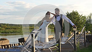 Newlywed couple standing on dock