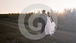 Newlywed couple at sunset