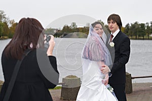 Newlywed happy people are photographed