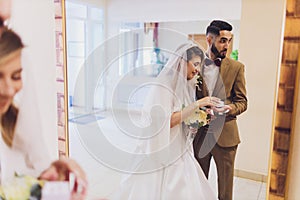 Newlyweds append signatures in a registry office during wedding registration.