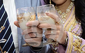 newlyweds Arabian in their hands cups of milk.