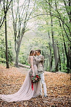 Newlyweds in an autumn romantic forest. Wedding ceremony outdoors.