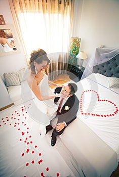 Newlyweds in bedroom with heart