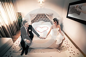 Newlyweds in bedroom with heart