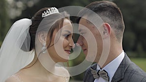 Newlyweds. Caucasian groom with bride walking, embracing, hugs in park. Wedding couple