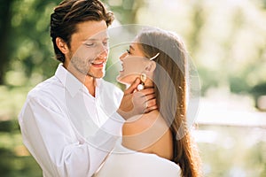 Newlyweds Couple Hugging Before Kiss At Wedding Ceremony In Park