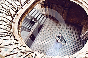 Newlyweds dancing in an old house