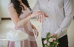 Newlyweds demonstrate wedding rings.