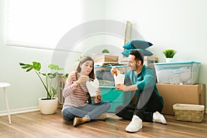 Newlyweds eating fast food in their new living room