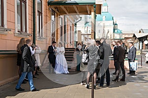 Newlyweds are going to let go into the sky a couple of pigeons after the wedding ceremony near the House of family celebrations.