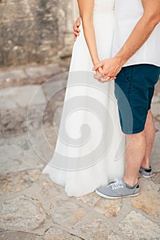 The newlyweds hold hands. Couple holding hands. Wedding in Monte