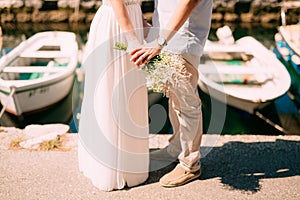 Newlyweds hold hands on the sea. Couple holding hands. Wedding i