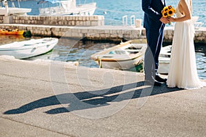 Newlyweds hold hands on the sea. Couple holding hands. Wedding i