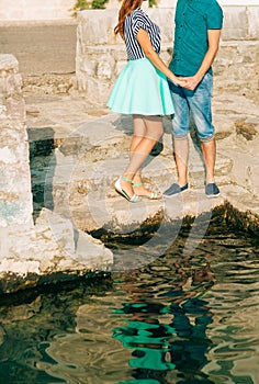 Newlyweds hold hands on the sea. Couple holding hands. Wedding i