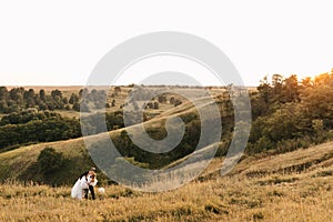 Newlyweds in love. The groom holds the bride in his arms. Beautiful view of nature