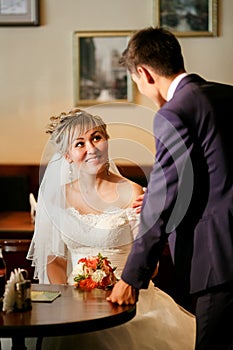 Newlyweds meeting in cafe, man asks woman sitting at table, showing interest, proposal.