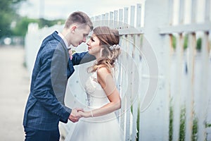 Newlyweds near the iron fence. Linear perspective