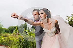 Newlyweds in a superman pose