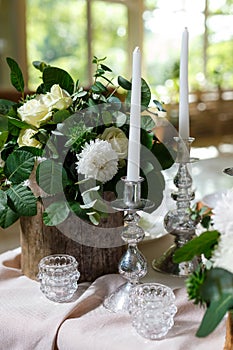 Newlyweds table setting decorated in rustic style. Nature theme in decoration