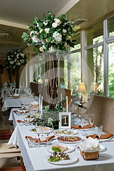 Newlyweds table setting decorated in rustic style. Nature theme in decoration