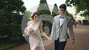 Newlyweds walk in the garden and have fun