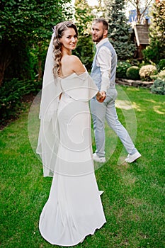 Newlyweds on a walk in a summer park. wedding photo shoot