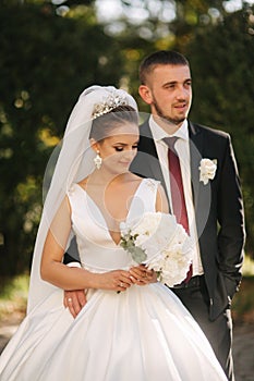 Newlyweds are walking in the park. Wedding couple in autumn