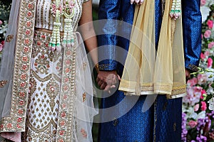 The newlyweds warmly held hands in the wedding ceremony.