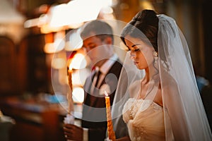 Newlyweds wedding ceremony in the church,wedding ceremony, glans