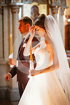 Newlyweds wedding ceremony in the church,wedding ceremony, glans