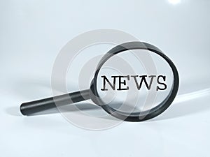 NEWS in black word with magnifying glass with white background.