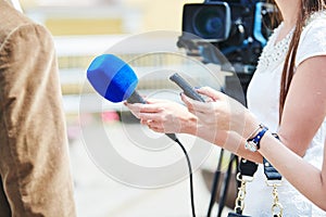 News comment. reporter with microphone making interview