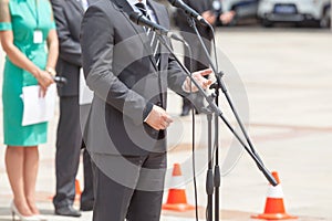 News conference. Politician is giving a speech.