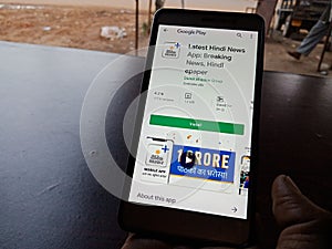 Latest Hindi news android app displayed on smart phone screen holded hand mobile concept in India dec 2019