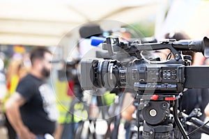 News or press conference. Filming media event with a video camera