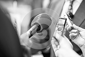News or press conference or media interview, digital voice recorder dictaphone and microphone in focus