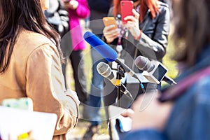 News or press conference microphone in focus, mobile journalist filming media event with a smartphone