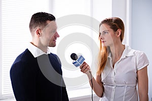 News Reporter Asking Question To Businessman