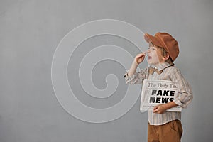 Newsboy shouting against grunge wall background. Boy selling fake news